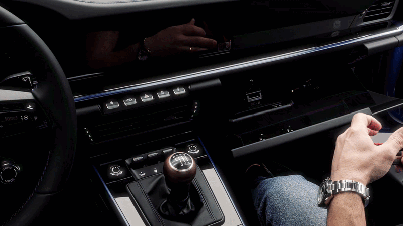 The mount sliding into the glovebox pen-holder slot, no tools.