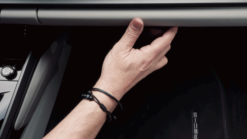 The mount sliding into the glovebox pen-holder slot, no tools.